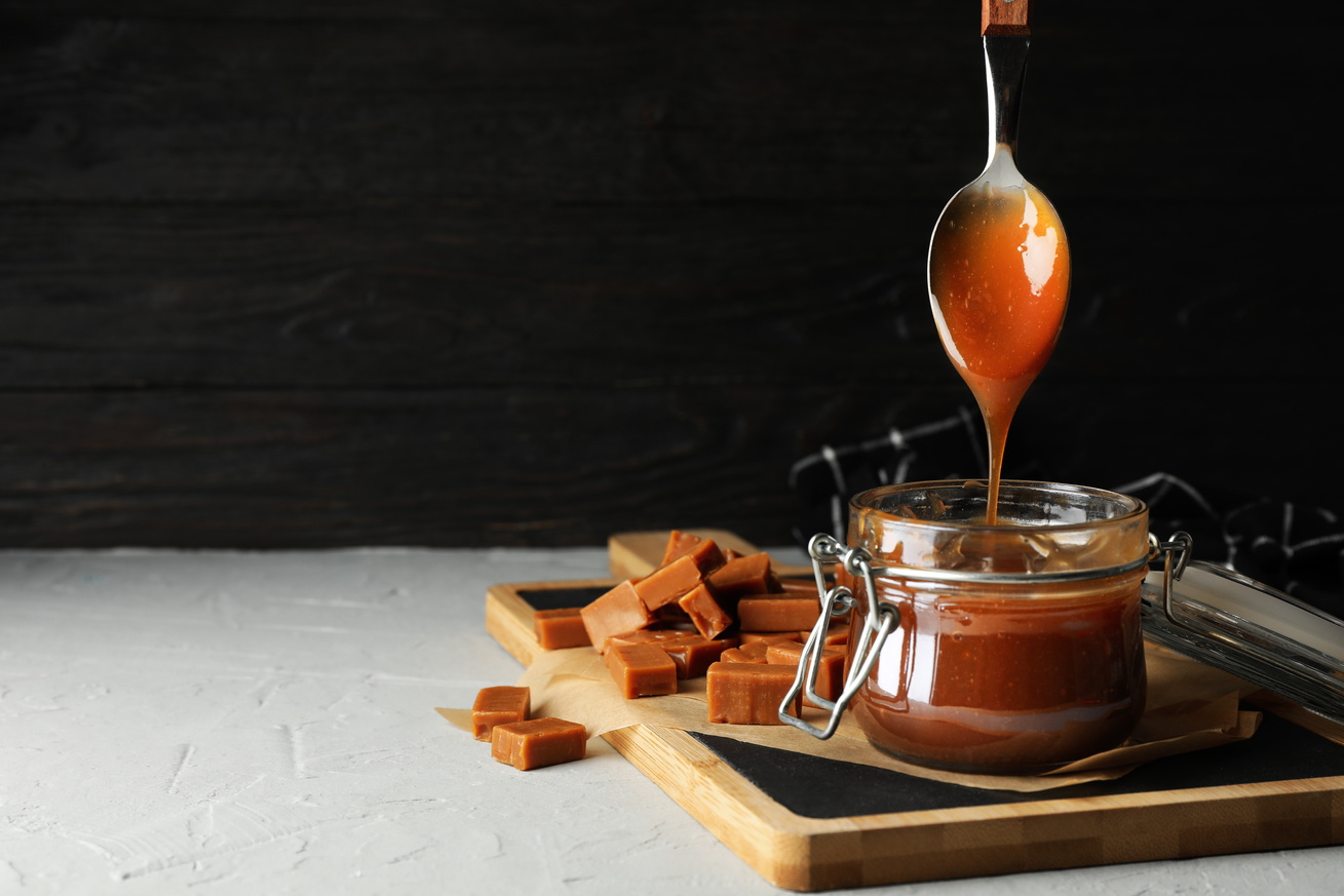 Dripping Caramel Syrup in a Jar from a Spoon